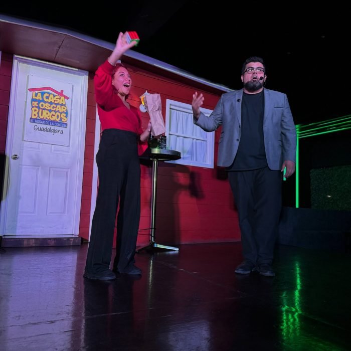 El mago profesional Eduardo Aviña terminando con éxito un truco de magia de cubos rubik junto a una persona que participó del público